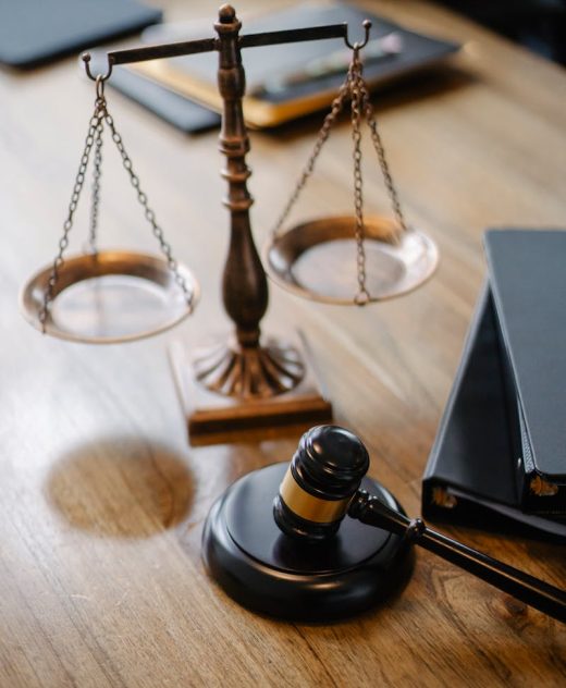 A striking image featuring a brass justice scale and gavel on a wooden desk, symbolizing law and justice. {{brizy_dc_image_alt imageSrc=